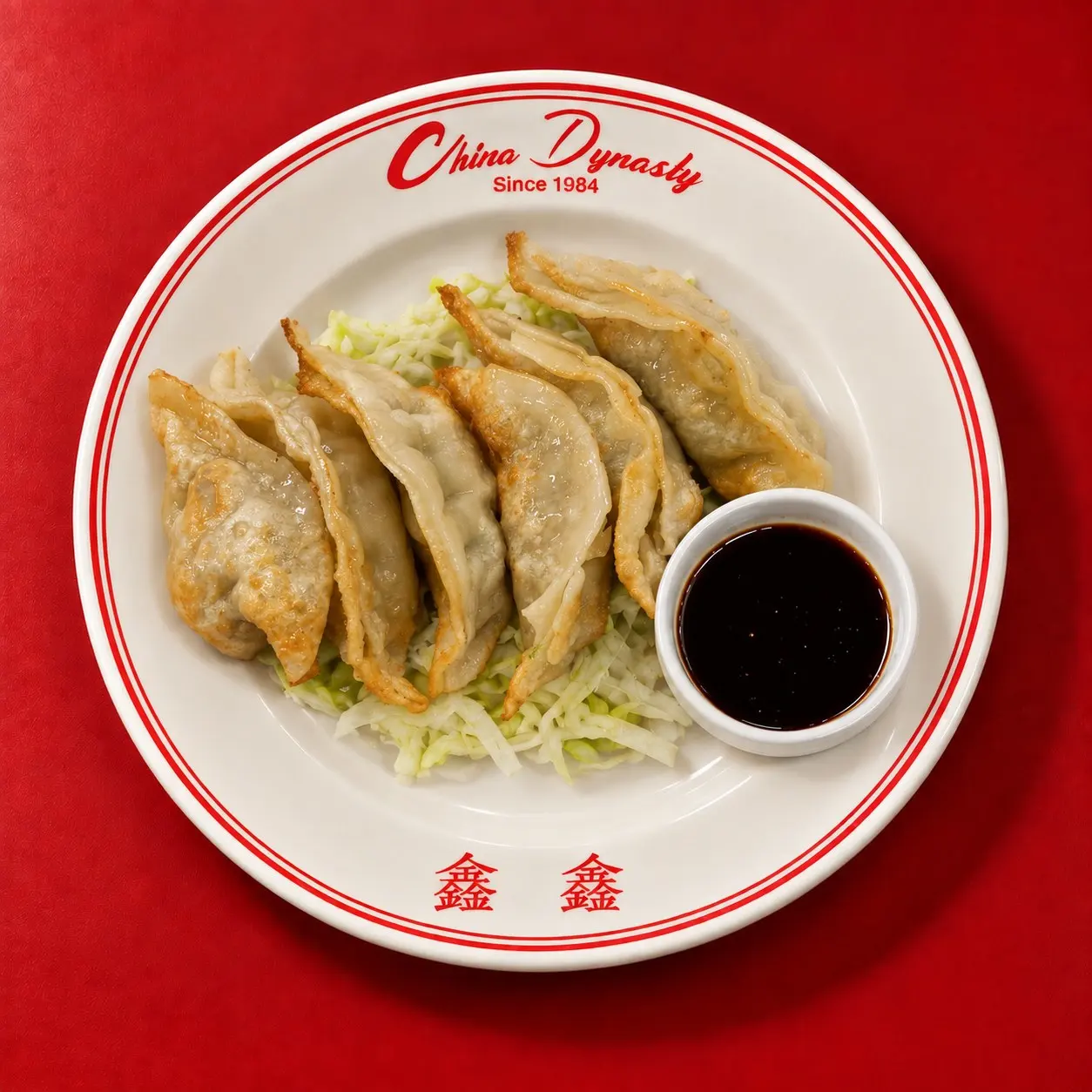 Pan-fried pork potstickers with crispy bottoms and dumpling sauce, an Austin Chronicle Critics’ Pick